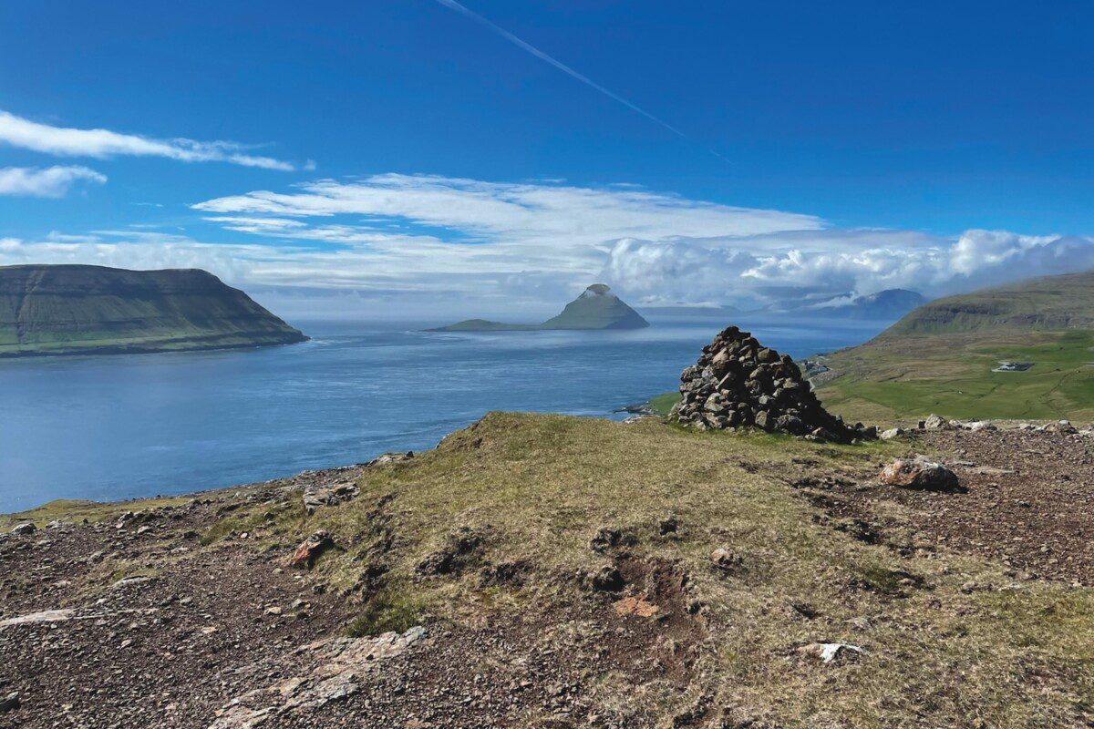 Landscape scene of a rocky outcrop looking over a calm deserted stretch of water